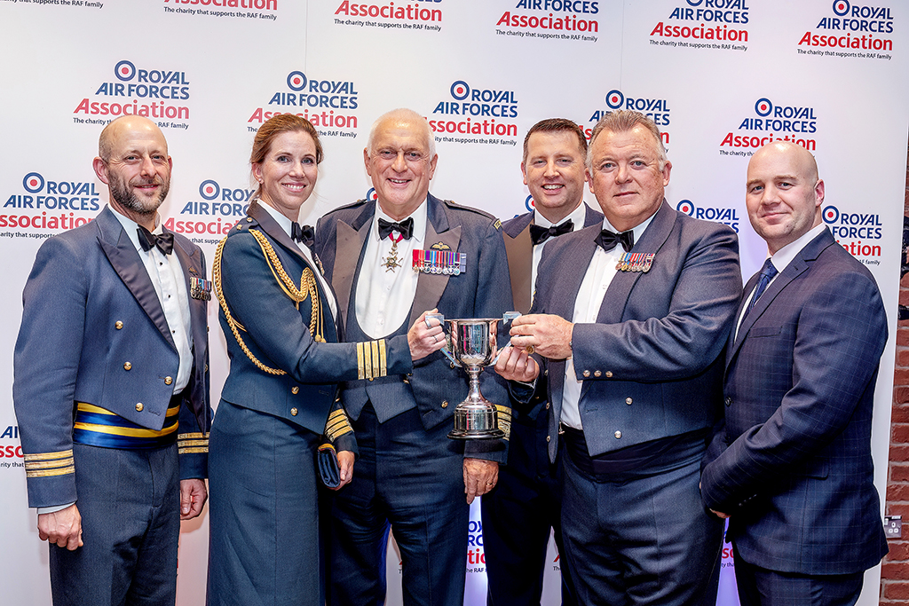 The Lord Tedder Trophy award was collected on behalf of the Station by Group Captain Henton, Wing Commander Stringer, Chief Technician Craven and Sergeant Anstis. They are seen in this group image, standing with the trophy.